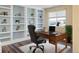 Home office with built-in shelving and hardwood floors at 33 Gaviota Ave, Brighton, CO 80601