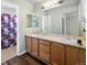 Double vanity bathroom with wood cabinets and shower at 33 Gaviota Ave, Brighton, CO 80601
