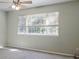 Spacious bedroom with large window, ceiling fan, and neutral walls at 33 Gaviota Ave, Brighton, CO 80601