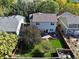 Backyard with deck, grass, and mature trees. Surrounding homes visible at 33 Gaviota Ave, Brighton, CO 80601