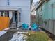 Small backyard with patio, seating area, and partial snow cover at 1450 N Williams St, Denver, CO 80218