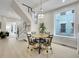 Light-filled dining area with a wooden table and four chairs at 1450 N Williams St, Denver, CO 80218