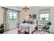 Bedroom with metal bed frame, two-toned wall decor, and large windows at 11038 Snowdon St, Parker, CO 80134