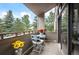 Small balcony with table and chairs, offering a view of trees at 23602 Pondview Pl, Golden, CO 80401