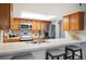 Kitchen boasts stainless steel appliances and wood cabinets at 23602 Pondview Pl, Golden, CO 80401