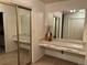 Vanity area with a large mirror and built-in drawers at 6300 W Mansfield Ave # 64, Denver, CO 80235