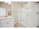 Bathroom with shower, white tile, and modern vanity at 461 Interlocken Blvd # 105, Broomfield, CO 80021
