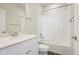 Bathroom with tub and shower, white tile, and modern vanity at 461 Interlocken Blvd # 105, Broomfield, CO 80021