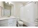 Bathroom with tub, white tile, and modern vanity at 461 Interlocken Blvd # 105, Broomfield, CO 80021