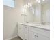 Double vanity bathroom with modern fixtures and large mirror at 461 Interlocken Blvd # 105, Broomfield, CO 80021
