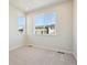 Bright bedroom with neutral walls and carpet, featuring two windows at 461 Interlocken Blvd # 105, Broomfield, CO 80021