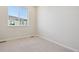 Well-lit bedroom with carpet flooring and a large window offering natural light at 461 Interlocken Blvd # 105, Broomfield, CO 80021
