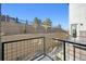 Private deck overlooking a landscaped hillside with a retaining wall and pathway at 461 Interlocken Blvd # 105, Broomfield, CO 80021
