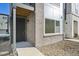 Modern front entrance with a dark door and stone accents at 461 Interlocken Blvd # 105, Broomfield, CO 80021