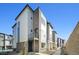 Modern three-story townhome with a balcony and attached garage at 461 Interlocken Blvd # 105, Broomfield, CO 80021