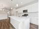 Island kitchen with white cabinets and quartz countertops at 461 Interlocken Blvd # 105, Broomfield, CO 80021