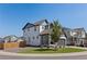 Exterior view of a modern two-story home with a fenced yard and a driveway at 27873 E 6Th Pl, Aurora, CO 80018