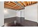 Unfinished basement with dark hardwood floors at 11401 Red Cloud Peak, Littleton, CO 80127