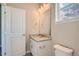 Simple bathroom with granite countertop vanity, toilet and mirror at 2549 Lupton Ln, Lafayette, CO 80026