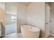 Luxurious bathroom with a large oval soaking tub and view into bedroom at 2549 Lupton Ln, Lafayette, CO 80026