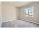Spacious bedroom with neutral carpeting and large window at 2549 Lupton Ln, Lafayette, CO 80026