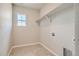 Laundry room with window, shelving, and tile flooring at 2549 Lupton Ln, Lafayette, CO 80026