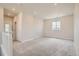 Open loft area with neutral carpet, window, and adjacent hallway at 2549 Lupton Ln, Lafayette, CO 80026