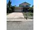 Two-story house with a stone facade, attached garage, and landscaped yard at 14190 E Gunnison Pl, Aurora, CO 80012
