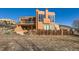 Exterior view of a southwestern home with a deck and fenced yard at 6697 Wauconda Dr, Larkspur, CO 80118