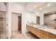 Modern double vanity bathroom with marble countertops, dual sinks, and a walk-in shower at 6697 Wauconda Dr, Larkspur, CO 80118