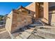 Stone steps and walkway leading to the entrance of a home with a stone and stucco exterior at 6697 Wauconda Dr, Larkspur, CO 80118