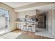 Bright kitchen features stainless steel appliances and a breakfast bar at 9079 E Nassau Ave, Denver, CO 80237