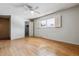 Bright bedroom featuring hardwood floors and a ceiling fan at 9079 E Nassau Ave, Denver, CO 80237