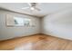 Spacious bedroom with hardwood floors and large window with shutters at 9079 E Nassau Ave, Denver, CO 80237