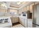 Updated kitchen with built-in oven and ample cabinet space at 9079 E Nassau Ave, Denver, CO 80237