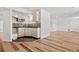 Basement wet bar with wood flooring and ample cabinet space at 4307 Opal Ct, Castle Rock, CO 80104