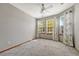 Spacious bedroom with carpeted floors, ceiling fan, and large windows at 8201 S Winnipeg Ct, Aurora, CO 80016