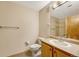Clean bathroom with single sink vanity, toilet, and shower at 8201 S Winnipeg Ct, Aurora, CO 80016