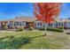 Rear view of charming home with well-manicured lawn at 8201 S Winnipeg Ct, Aurora, CO 80016