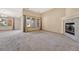 Living room with fireplace, carpeted floors, and adjacent dining area at 8201 S Winnipeg Ct, Aurora, CO 80016
