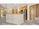 Kitchen with light wood cabinets, stainless steel appliances, and breakfast bar at 8201 S Winnipeg Ct, Aurora, CO 80016