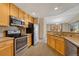 Modern kitchen featuring stainless steel appliances and light wood cabinets at 8201 S Winnipeg Ct, Aurora, CO 80016