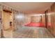 Unfinished basement area with wood paneling and red carpet at 4020 Newman St, Wheat Ridge, CO 80033