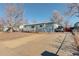 Blue house with a driveway and a spacious yard at 4020 Newman St, Wheat Ridge, CO 80033