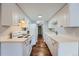 White kitchen features hardwood floors and modern appliances at 6420 S Dayton St # J06, Englewood, CO 80111