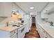 Bright eat-in kitchen with white cabinetry, modern appliances, and hardwood floors at 6420 S Dayton St # J06, Englewood, CO 80111