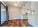 Dining area with hardwood floors and kitchen with white cabinets at 6420 S Dayton St # J06, Englewood, CO 80111