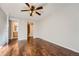 Bedroom with hardwood floors, ceiling fan, and access to bathroom at 6420 S Dayton St # J06, Englewood, CO 80111