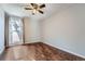 Bright bedroom with wood floors and a ceiling fan at 6420 S Dayton St # J06, Englewood, CO 80111