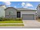 Ranch-style home with a gray exterior, stone accents, and a two-car garage at 9674 Truckee St, Commerce City, CO 80022